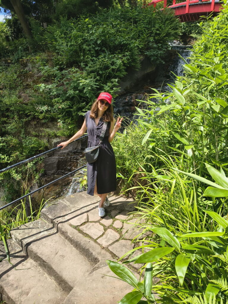 Frau auf einer Treppe im grünen Japanischen Garten